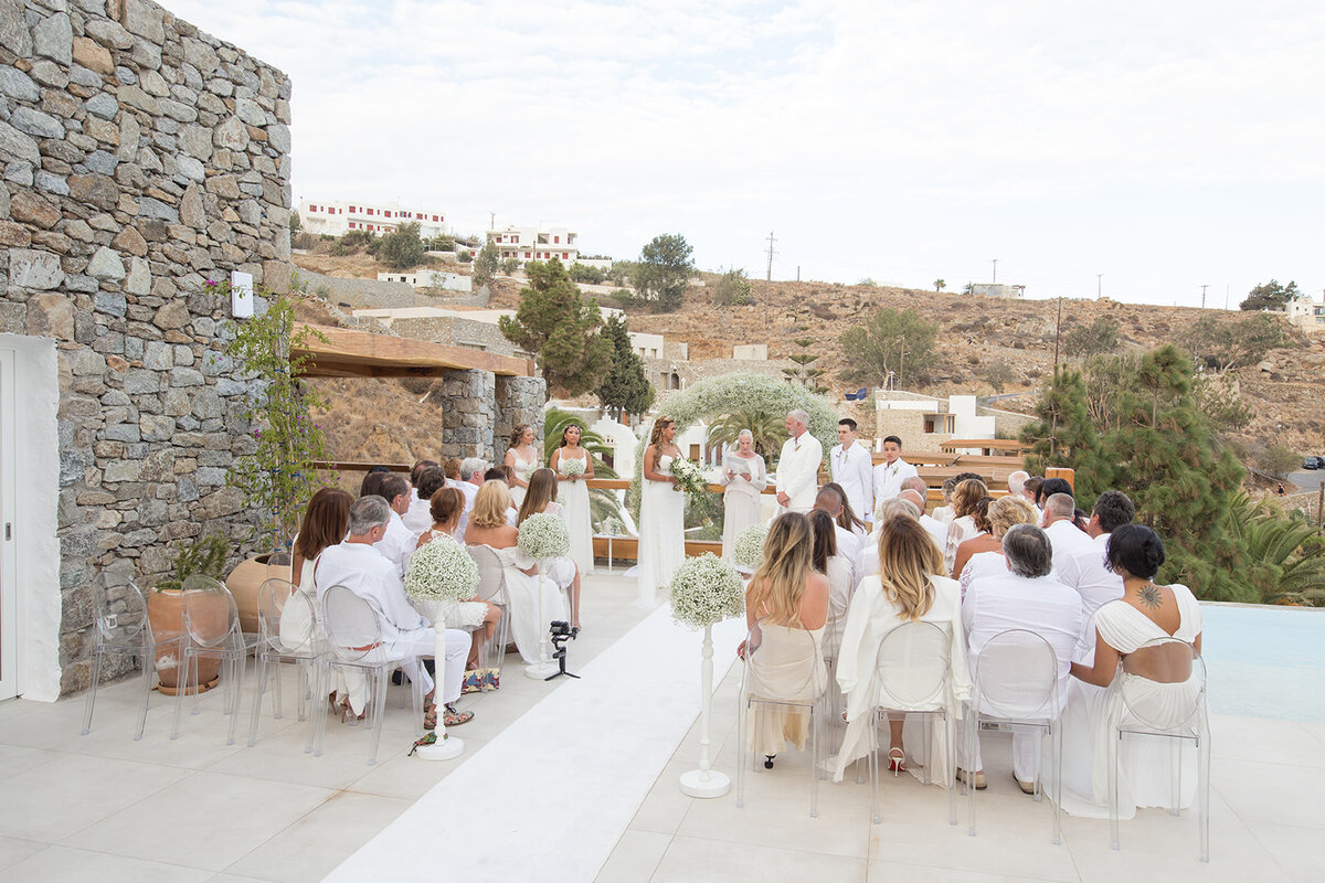A beautifully intimate micro wedding setup in Mykonos, featuring a stunning seaside ceremony with elegant details.
