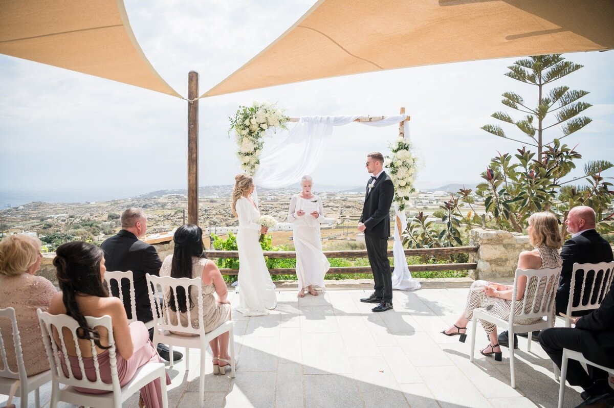 A beautifully intimate micro wedding setup in Mykonos, featuring a stunning seaside ceremony with elegant details.