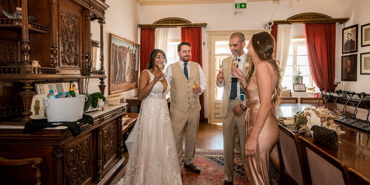 Newlyweds share a joyful moment in the elegant room of a Mykonos Town Hall after their civil ceremony.